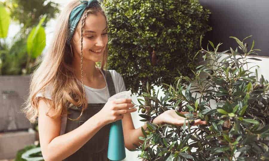 mulher pulverizando plantas
